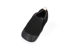 Calzado respetuoso Xplorer Scamp orgánico negro de BOBUX para los primeros pasos del bebé, con suela flexible y cierre ajustable.